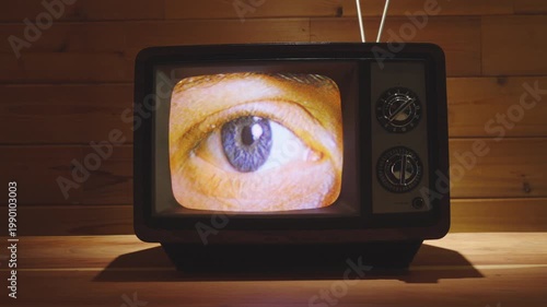 Closeup of an eye on a vintage 80's television