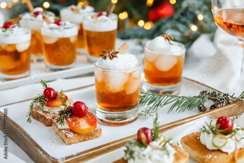 Holiday cocktails and appetizers with berries and spices festive food drink