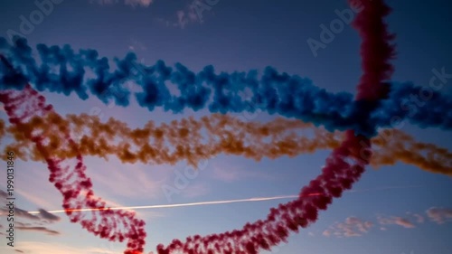 Colorful Smoke Trails from Airplanes in the Sky at Sunset