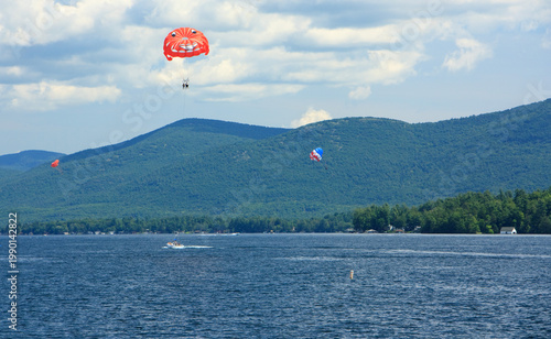 People parasailing over Lake George in New York during summer