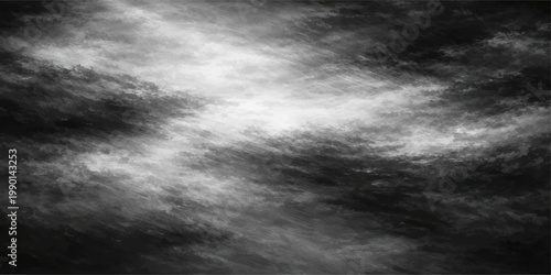 Dramatic dark storm clouds create an abstract black and white texture of swirling fog and misty rain across an overcast night sky backdrop