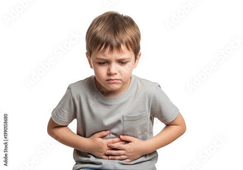 Young boy holding his stomach with a concerned expression on his face