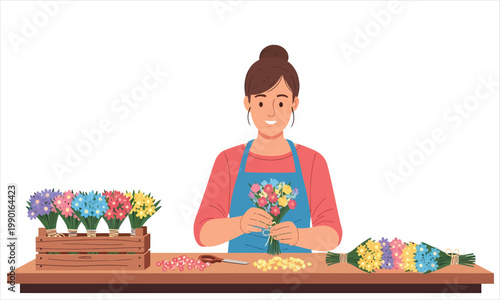 A florist carefully ties a small bouquet of colorful flowers at a worktable