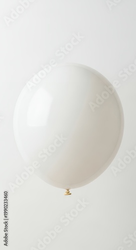 White Balloon Floating Against a Clean, Minimalist Background.