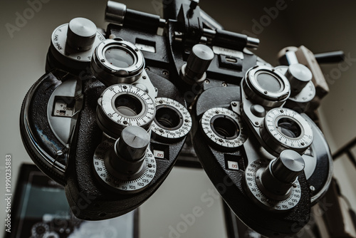 Close up view of phoropter tool for vision correction. Angled shot of professional phoropter equipment used by optometrist for eye testing and diagnosis.