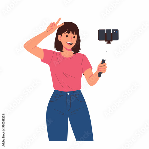 Happy young woman vlogger making a peace sign while recording a video with her smartphone on a selfie stick.