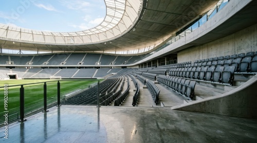 Modern empty soccer stadium with grey seats and concrete architecture