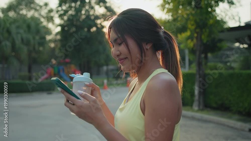 Young active woman drink whey protein shake bottle eating diet food using phone calorie AI plan app after workout health care asia people happy relax anti aging life weight loss walk public green park