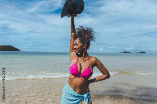 Sunlit beach, turquoise waves, distant islands