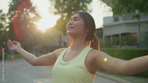 Asia young Gen Z people mindful happy woman open arm relax body deep stress relief outdoor nature green public park sun light self love anti aging life mental health care modern medical asian female.
