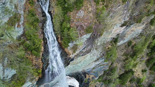 Aerial tilt view of Jungfernsprung Waterfall in forest mountain. Austrian Alps, Austria, 4k