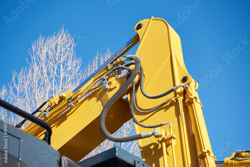 Excavator arm with hydraulic hoses and cylinder detail