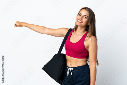 Young sport Uruguayan woman with sport bag isolated on white background giving a thumbs up gesture