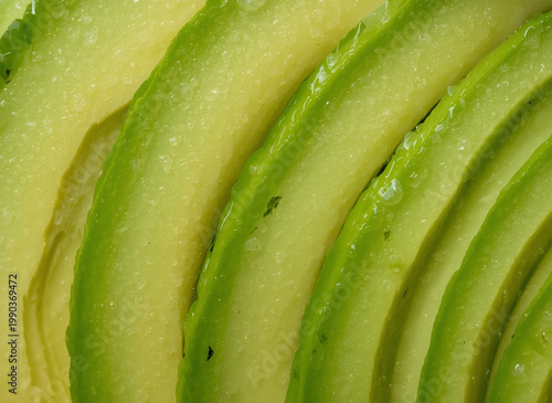    Slices of avocado as a background. Close-up.