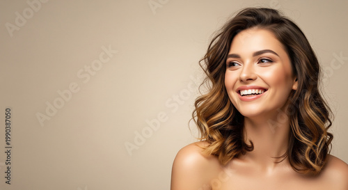 Happy beautiful woman laughing with glowing skin perfect for highlighting healthy skincare routines and modern beauty care