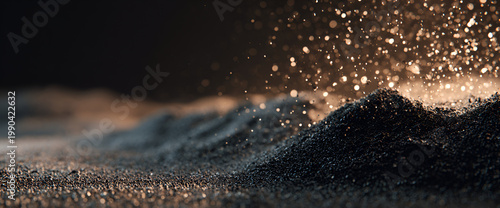 Close-up of a textured, granular surface. Floating, shimmering particles create a magical and ethereal effect. The backdrop fades from dark to light