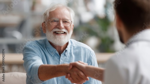 Older man shaking hands with younger person