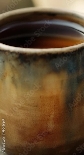 A close-up shot of a cup of coffee on a table, ideal for use in food or beverage advertisements vertical frame