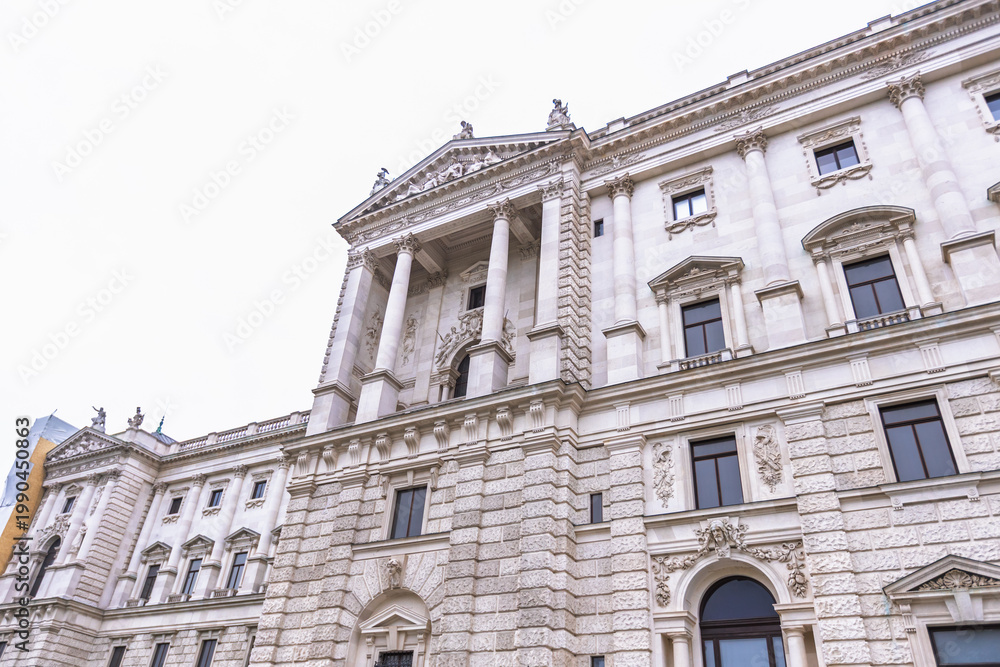 Fototapeta premium Detailed low-angle view of the ornate Neue Burg wing facade at Hofburg Palace in Vienna.