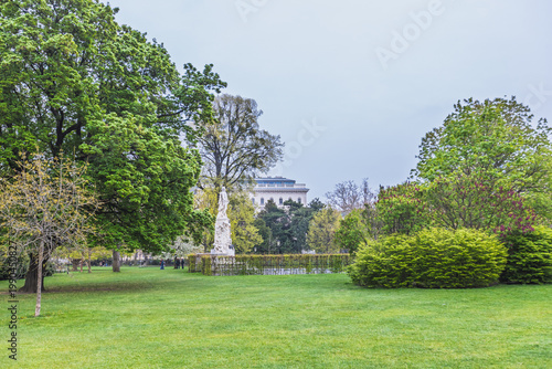 Burggarten park with Mozart monument and lush green trees in Vienna.