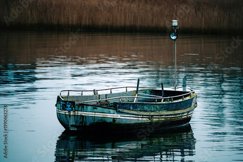 An old fishing boat in a bay on the shore of the Baltic Sea.
