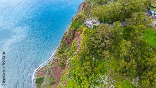 Aerial view of the stunning Cabo Girao skywalk and dramatic cliffs in Madeira, Portugal, offering breathtaking ocean vistas. A popular tourist destination.