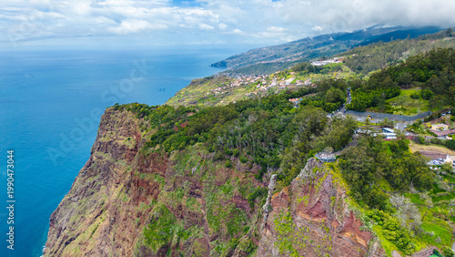 Breathtaking aerial view of Cabo Girão towering cliffs and the vibrant coastline of Madeira, Portugal. A popular viewpoint offering stunning Atlantic vistas.