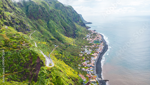 Paul do Mar, Madeira: A picturesque village nestled between towering green cliffs and the Atlantic Ocean. Winding roads offer breathtaking views of this charming coastal paradise.