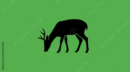 Silhouette of a deer grazing on green background.