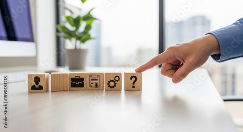 Strategic decision making a hand points to a question mark among wooden block icons representing business concepts