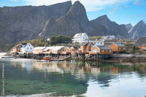 Obraz na plátně Colorful rorbuer on stilts with fjord and mountain backdrop in the Lofoten Islan