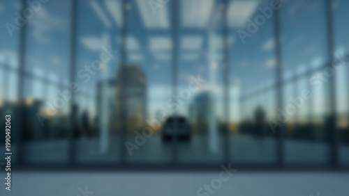 Modern architectural interior with glass windows and natural light, blurred background.