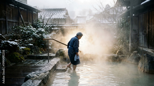 Elderly woman relaxing in steamy hot spring