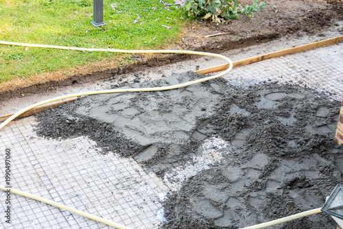 Vászonkép Pouring concrete over reinforcement mesh for slab foundation