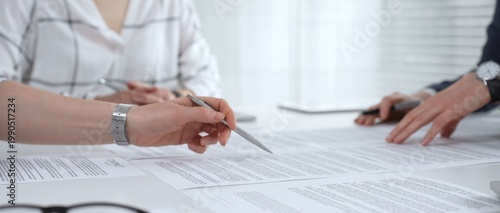 Foto Business partners discussing financial contracts, reviewing legal documentation,