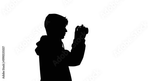 Silhouette of a person holding a camera and taking a photo.