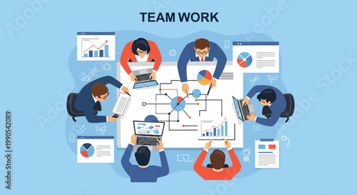 People engaged in team work around a table with charts, laptops, and reports in an office setting during daytime