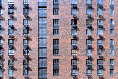 facade of a multi-storey building made of red brick. Brooklyn style