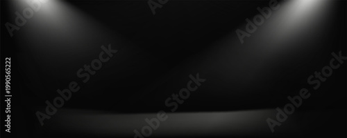 A stark, textured black surface is illuminated by a single, powerful beam of white light originating from the upper left, casting a dramatic spotlight.