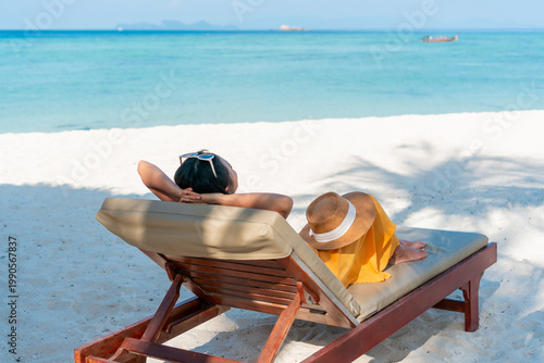 Happy Asian traveler woman relaxing at the beach. Summer and vacation concept. Copy space