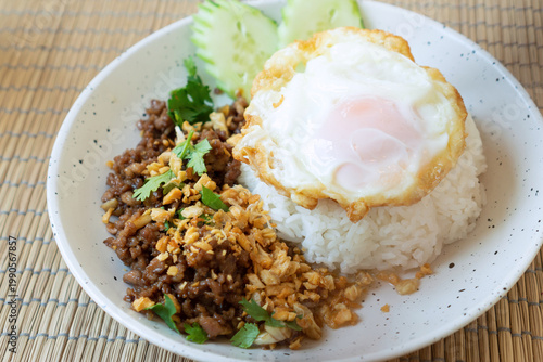 Homemade of garlic fried minced pork with rice and fried egg in Thai food style. Close up