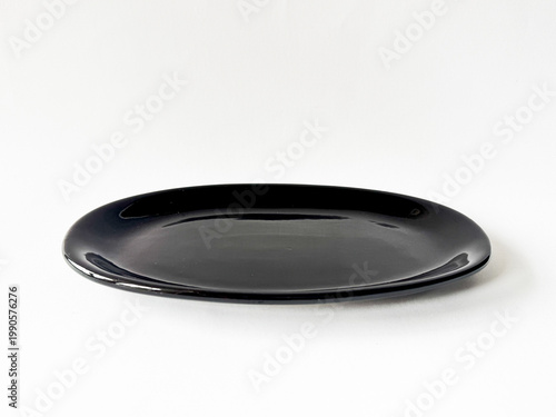 Black oval tray rests on clean white surface
