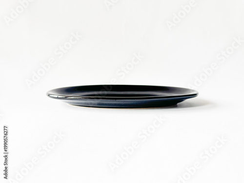 Black oval tray rests on clean white surface