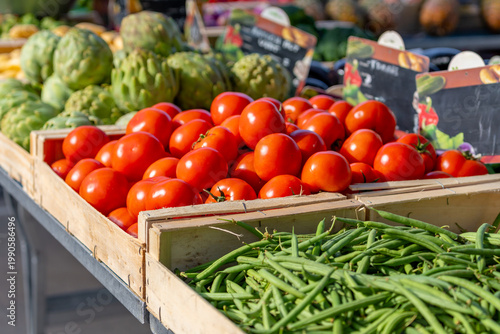 Tomatoes and various vegetables on a market stall