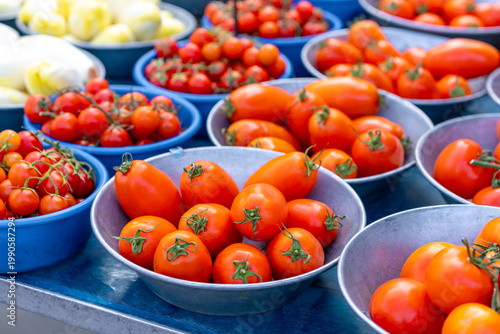 Tomatoes and various vegetables on a market stall