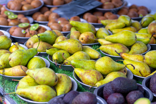 Pears and various fruits on a market stall