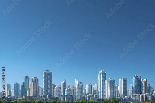 Modern city skyline with tall office towers and residential buildings under clear blue sky, showcasing urban architecture and vibrant city life in daylight