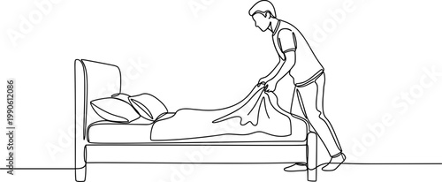 Man making a bed in bedroom.