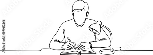 Man sitting at desk reading book.