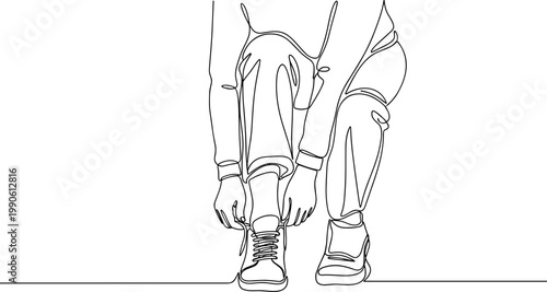 Person bending down to tie shoe.